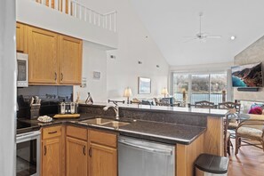 A modern kitchen with wooden cabinets, a stainless steel sink, and a dishwasher.