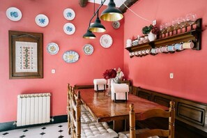 Enjoy meals in this elegant dining room with a traditional table for four, surrounded by matching chairs and decorative accents.