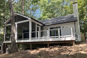 A two-story house with a covered porch and a chimney. - 2BR+Loft |Screened Patio| Lake Views at Arrowhead |Pool, Tennis, Boating, Hiking, Dining, Pickleball (Waleska)