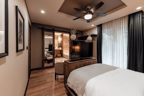 A modern hotel room with a large bed, a flat-screen TV, a ceiling fan, and a sliding door leading to a bathroom. - Casa Luciana Condesa (Mexico City)