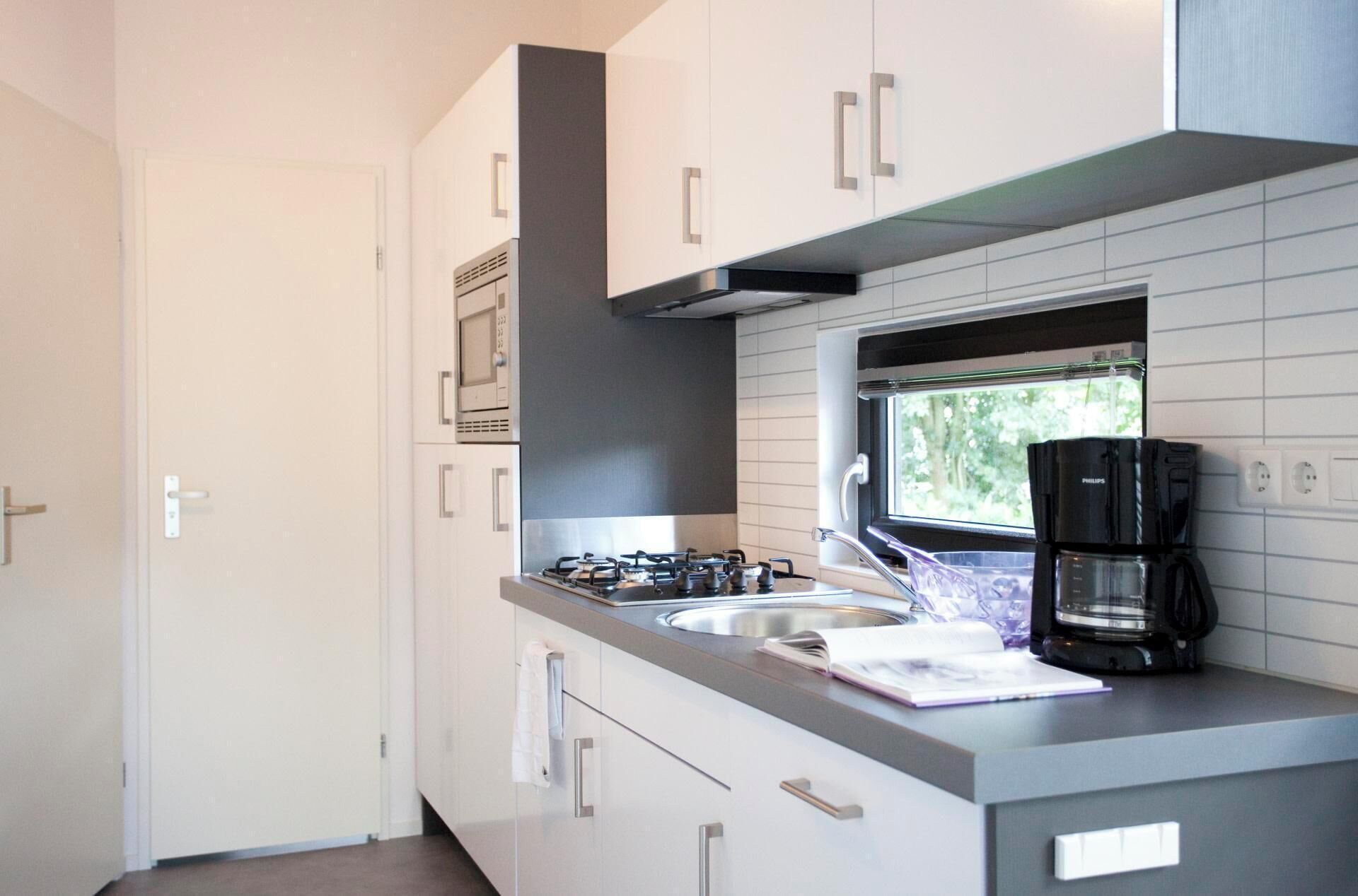 Een koelkast, een magnetron, een kookplaat, een vaatwasser