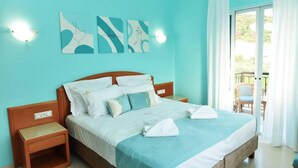 A bedroom with a bed, bedside tables, and artwork on the wall. - Christianna Luxury Apartment 2 (Apokoronas)