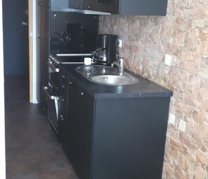 Fridge, stovetop, dishwasher, coffee/tea maker