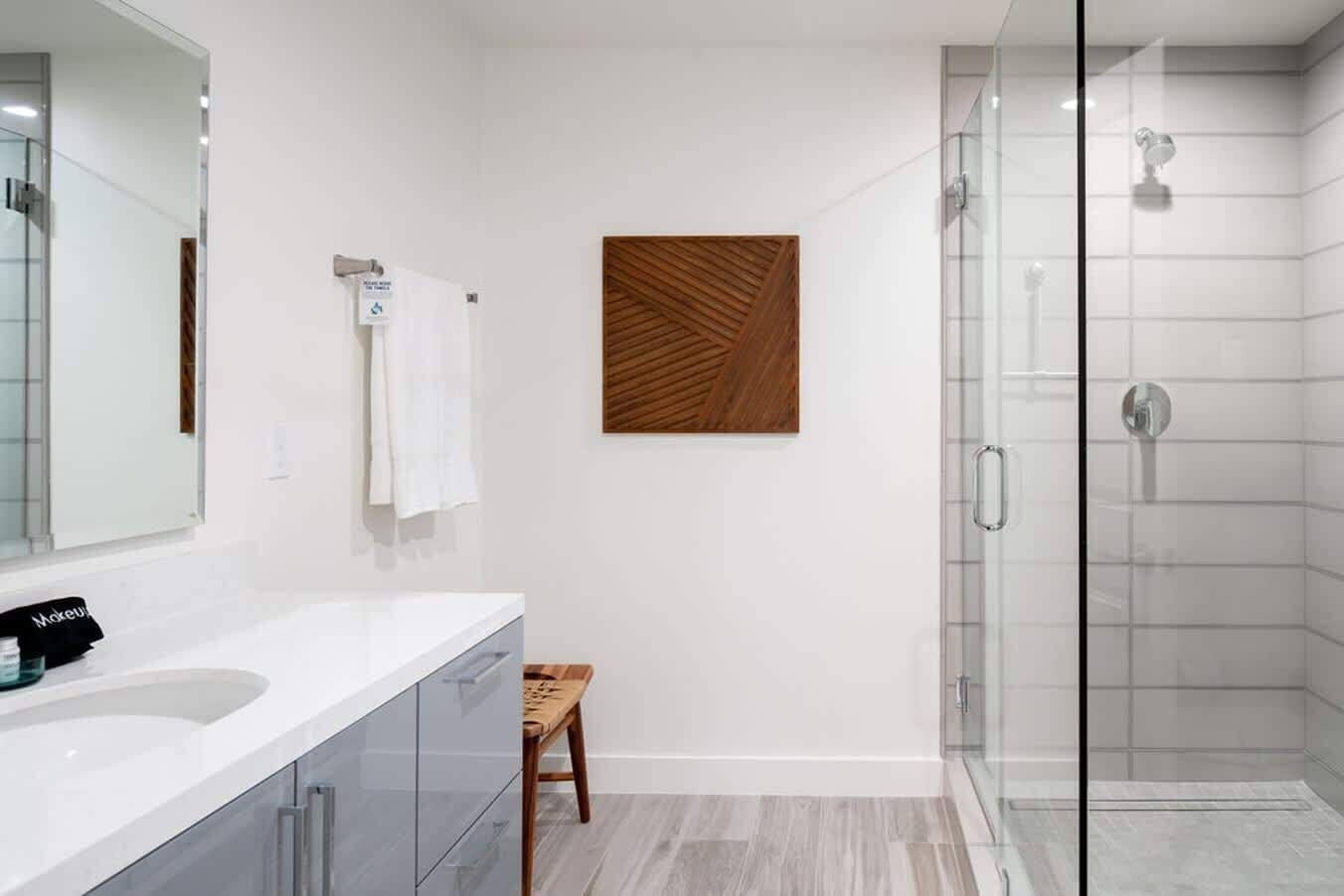 En-suite bathroom with a walk in shower in the handsome wood double queen guest bedroom.
