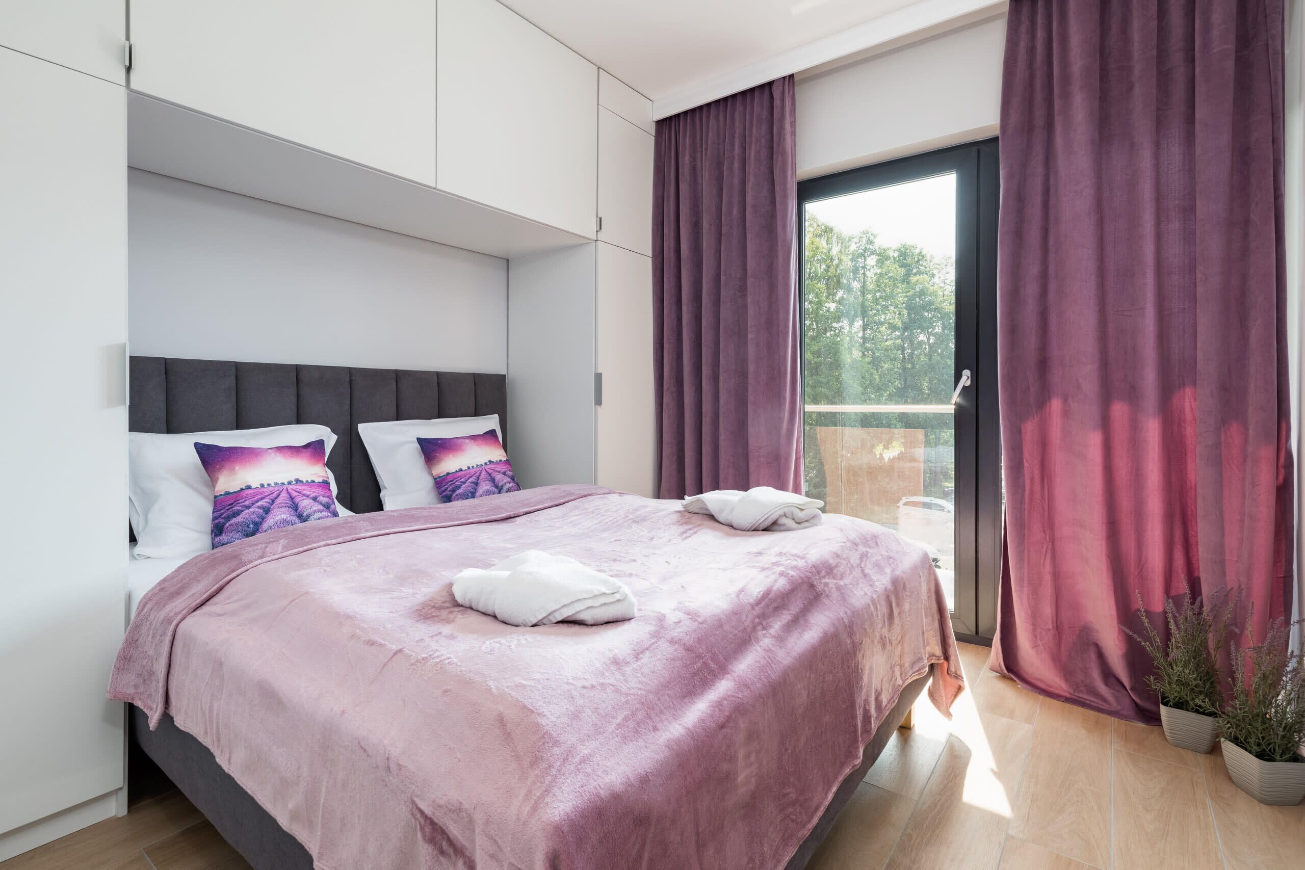 The cosy bedroom features a luxurious double bed and ample storage.