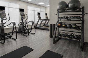 Stay fit on the go with our well-equipped gym featuring treadmills, a stationary bike, and free weights.