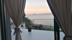 A balcony with a view of the sea and a distant ship. - Villa Molet (Koper)