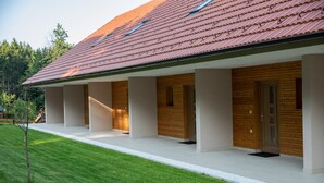 A modern building with a sloped roof and wooden paneling. - Hocka Koca (Hoce-Slivnica)