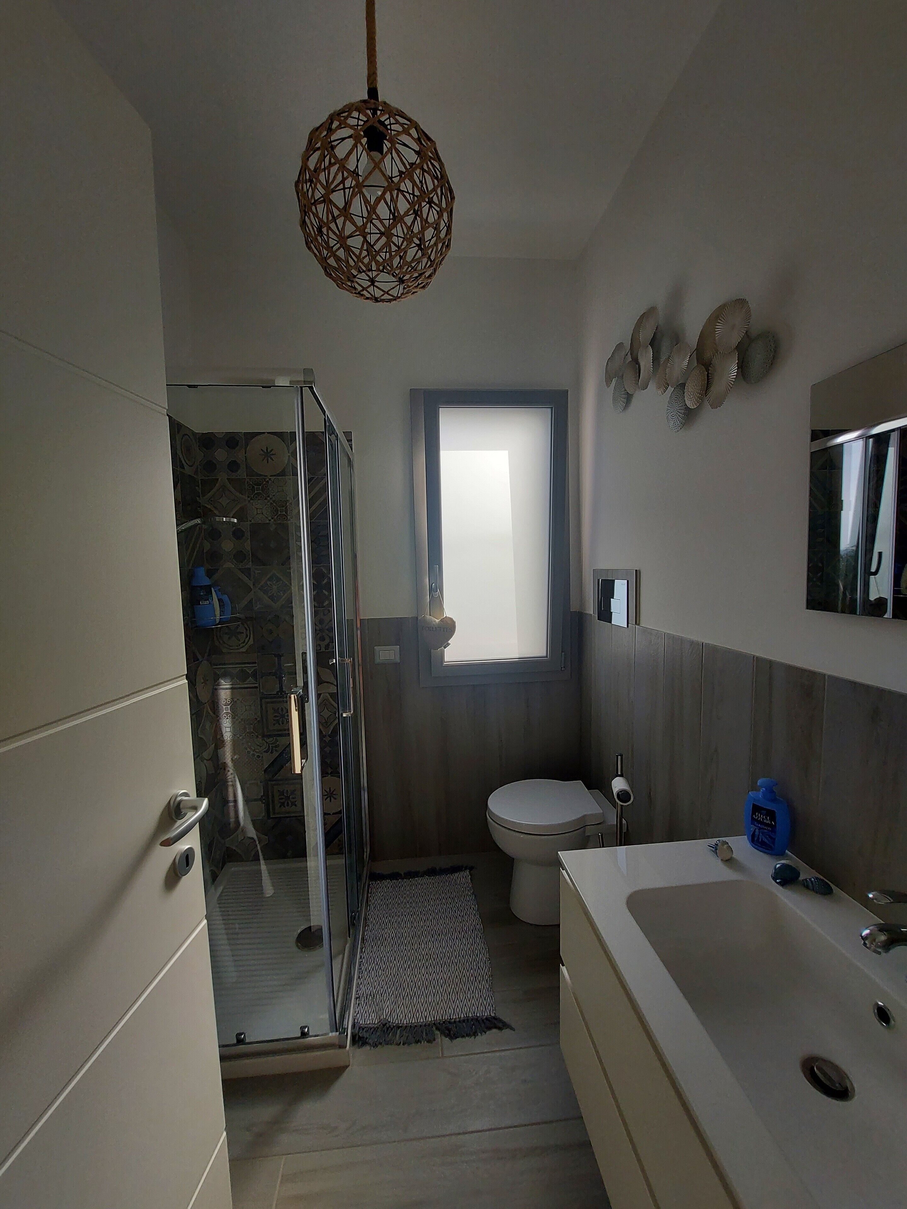 A bathroom with a shower, toilet, and bathtub.