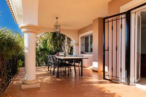 Enjoy al fresco dining on the patio, surrounded by lush gardens and a beautifully appointed dining area.