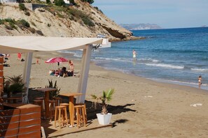 Relax in a beachside setting with ocean views, a covered seating area, and access to the beach.