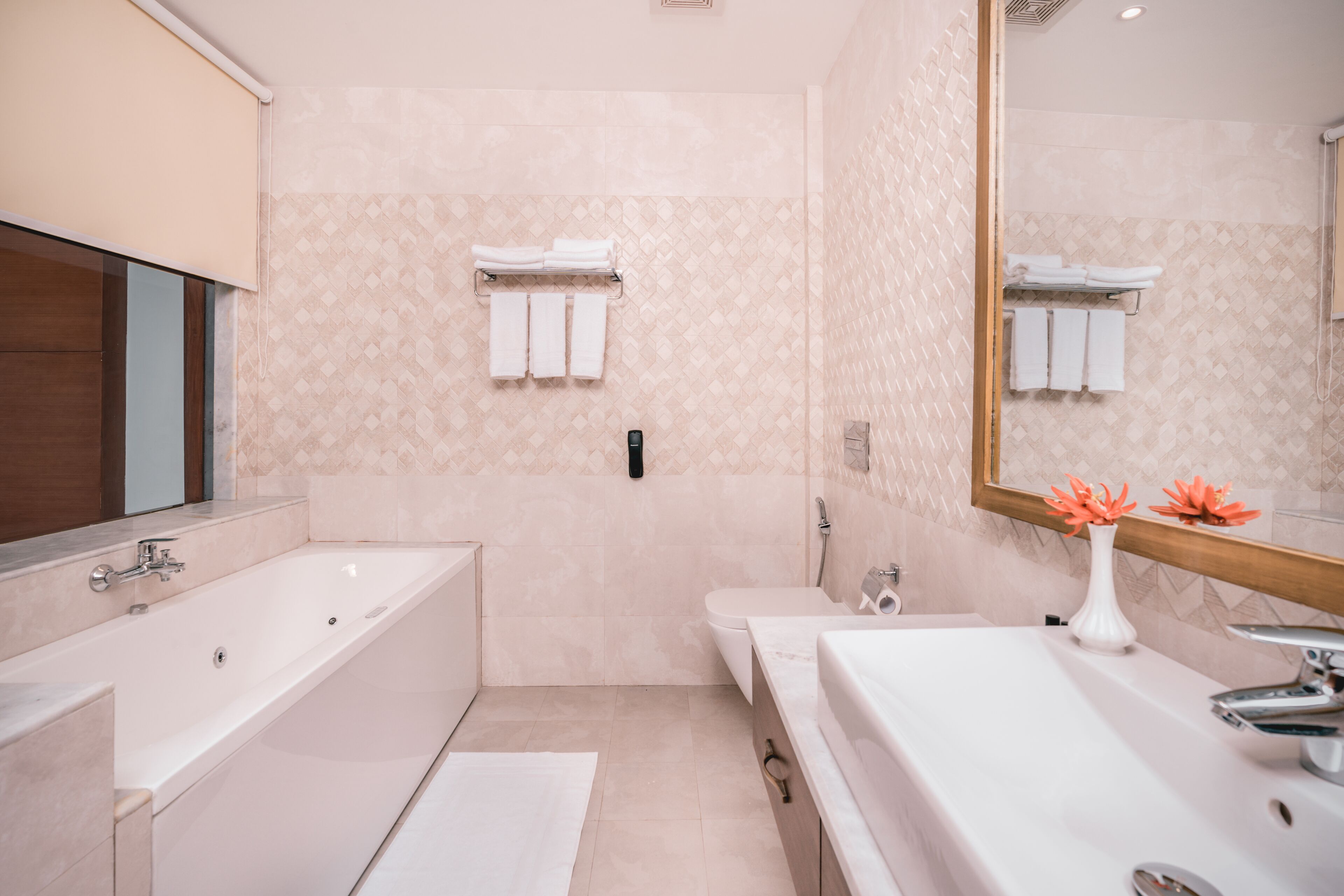 A modern bathroom with a large bathtub, a separate shower area, and a vanity with a sink.