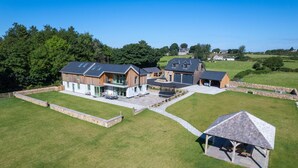 A large, modern house with multiple rooms and a spacious outdoor area.