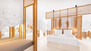 A modern hotel room with a large bed, a seating area, and a view of the city. - ANOME Mykonos (Mykonos)