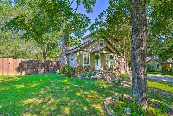 Stroll through the shaded grounds of this charming two-story home, surrounded by a well-manicured lawn and mature trees.