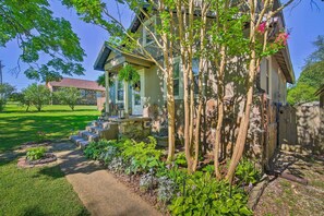 Stunning two-story house with a front porch and beautifully manicured lawn.