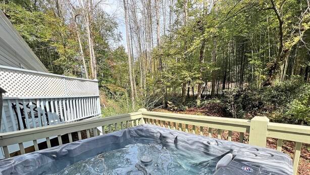 A hot tub on a wooden deck surrounded by trees. - Cuddle Cove Modern, Creekside Home right by the Heart of Bryson City (Bryson City)
