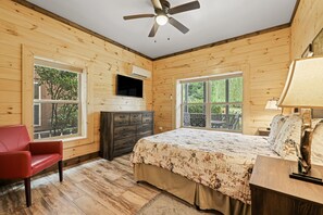 A bedroom with a bed, a dresser, a red chair, and a ceiling fan. - Huggie Bear Located in Bryson Village in Town. Pet Friendly! (Bryson City)