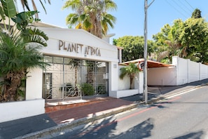 Surrounded by lush greenery, Planet Africa offers a serene environment with a contemporary design and a flat roof.
