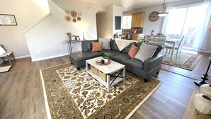 A modern living room with a sectional sofa, a coffee table, and a patterned rug. - Close to Montgomery Village and Flamingo Resort, just minutes to wineries (Santa Rosa)