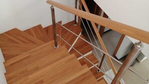 A wooden staircase with metal handrails and a white wall. - El Cotillo Sonando,Couples only, Romantic,Minutes from swim/surf,Well equipped. (El Cotillo)
