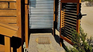 A wooden building with a metal gate and a wooden bench. - Spectacular panoramic views on nearly 10 acres, Stargazing, Spa, Family Friendly (Twentynine Palms)