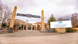 A hotel entrance with a sign reading "CONTINENT HOTEL - KAPADOKUS THERMAL - ILARA VALLEY - CAPPADOCIA". - Continent Hotel Kapadokus Thermal (Guzelyurt)