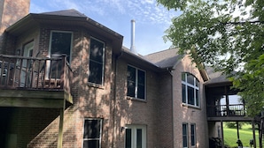 A two-story brick house with a balcony, a chimney, and a covered porch area. - 5-acres, Large 5-Bedroom Home with possible 6th Nursery next to Master Bedroom. (Morrow)