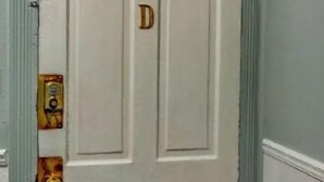 A white door with a letter 'D' on it, a small poster on the door, and a carpeted floor. - ❤DT Victorian Apt D❤ 1br~Walk to DT/APSU~Firepit❤ (Clarksville)