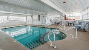 An indoor swimming pool with clear lanes, a diving area, and lounge chairs. - Whale's Tale - Boutique Studio Condo w/Pool 🐳 (Hampton)