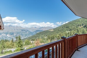 Enjoy breathtaking views of the surrounding mountains and valleys from this balcony.