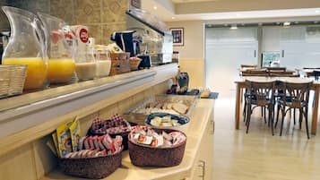 A breakfast buffet with various food items and beverages.