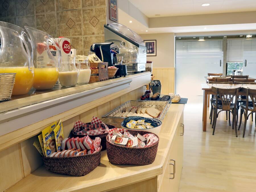 A breakfast buffet with various food items and beverages.