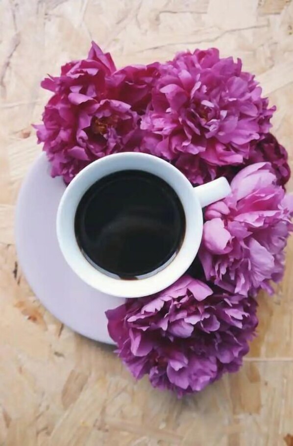 Coffee and fresh flowers set the tone for a serene morning.