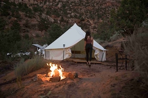 Experience the tranquility of nature in this secluded tent, complete with a campfire for warmth and ambiance.