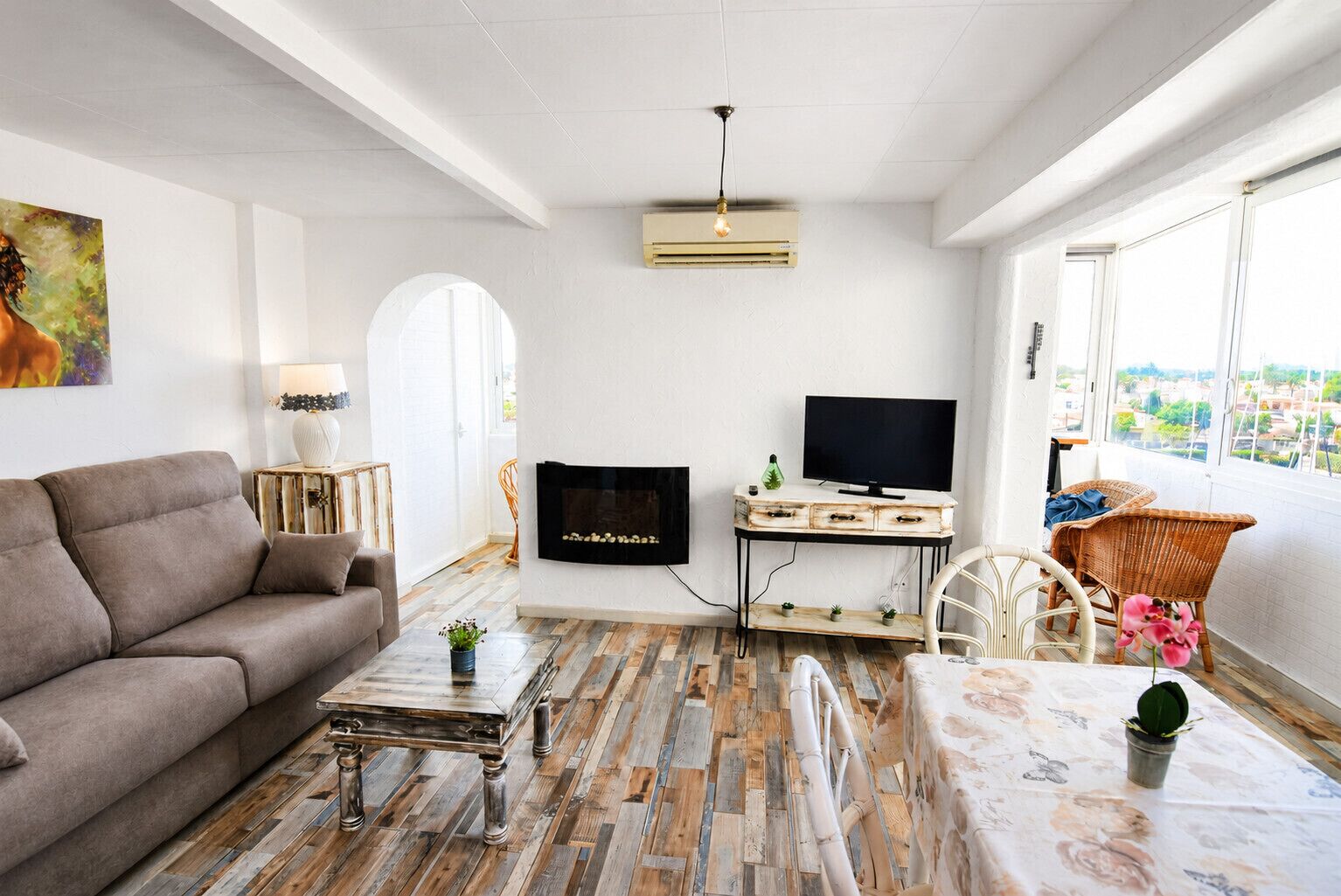 A living room with a sofa, TV, and a fireplace.