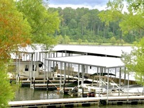 A docked boat with a covered area, surrounded by trees and a body of water. - Lake Sam Rayburn "True" Waterfront Escape - Bring Boat, Kayak & Fishing Poles! (Etoile)