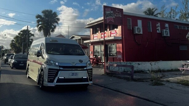 A white van parked on a street with a red building in the background. - Eudora House Barbados Modern 2 Bed Villa in Christ Church/Oistins (Sleeps 4) (Christchurch)