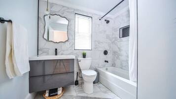 Bathtub, hair dryer, towels, soap