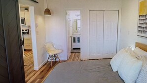 A bedroom with a bed, a chair, and a wardrobe. - Cozy Elk Hideaway - Walk to Ski Slopes!!! (Beech Mountain)