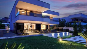 A modern two-story house with a swimming pool, outdoor seating, and a well-maintained garden. - Luxury Villa Cherry with indoor pool and outdoor jacuzzi (Marina)