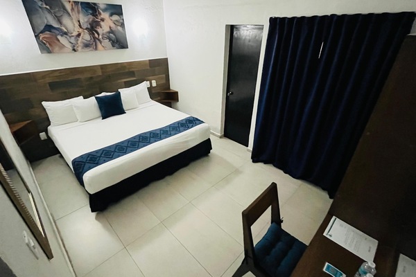 Habitación ejecutiva, 1 cama King size | Cortinas blackout, wifi gratis y ropa de cama