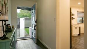 A modern kitchen with white cabinets and a built-in oven. - Uptown Area! Putting Green-BBQ-Hot Tub-Game Room (Albuquerque)