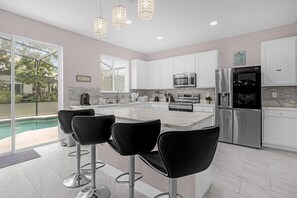Fridge, microwave, oven, stovetop -   Ultimate Disney Getaway  5 bedroom,  Poolside Relaxation  & Fun Game Room! (Clermont)