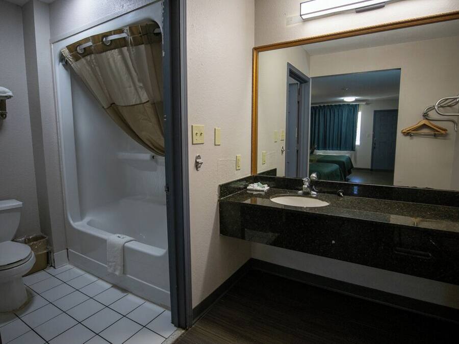 A bathroom with a bathtub, toilet, and sink.