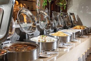 A buffet with various food items and utensils. - Changting Hotel (Changting)