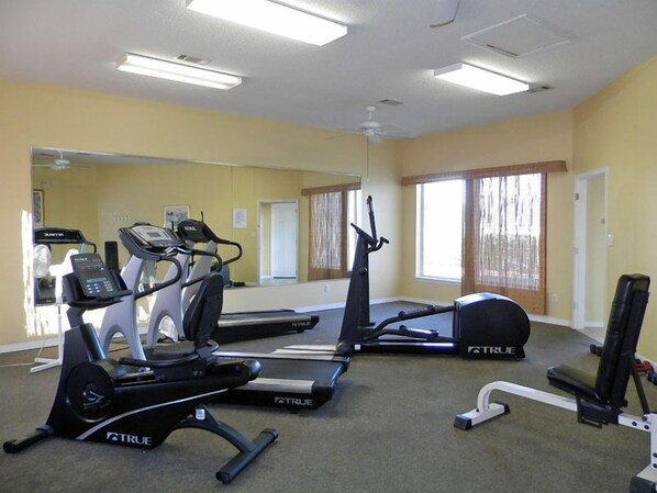 Ein Fitnessraum mit Laufbändern, Crosstrainern und Ergometer, alle mit dem Schriftzug 'A TRUE'.