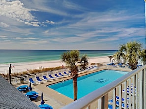 Relax by the pool overlooking the ocean and sandy beach.