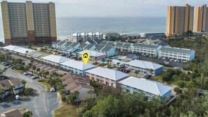 A coastal hotel complex with multiple buildings, including high-rise towers and smaller structures. - Wendwood #E1 by Resort Collection (Panama City Beach)