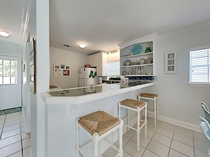 Enjoy cooking in this well-equipped kitchen with a central island, oven, and refrigerator.